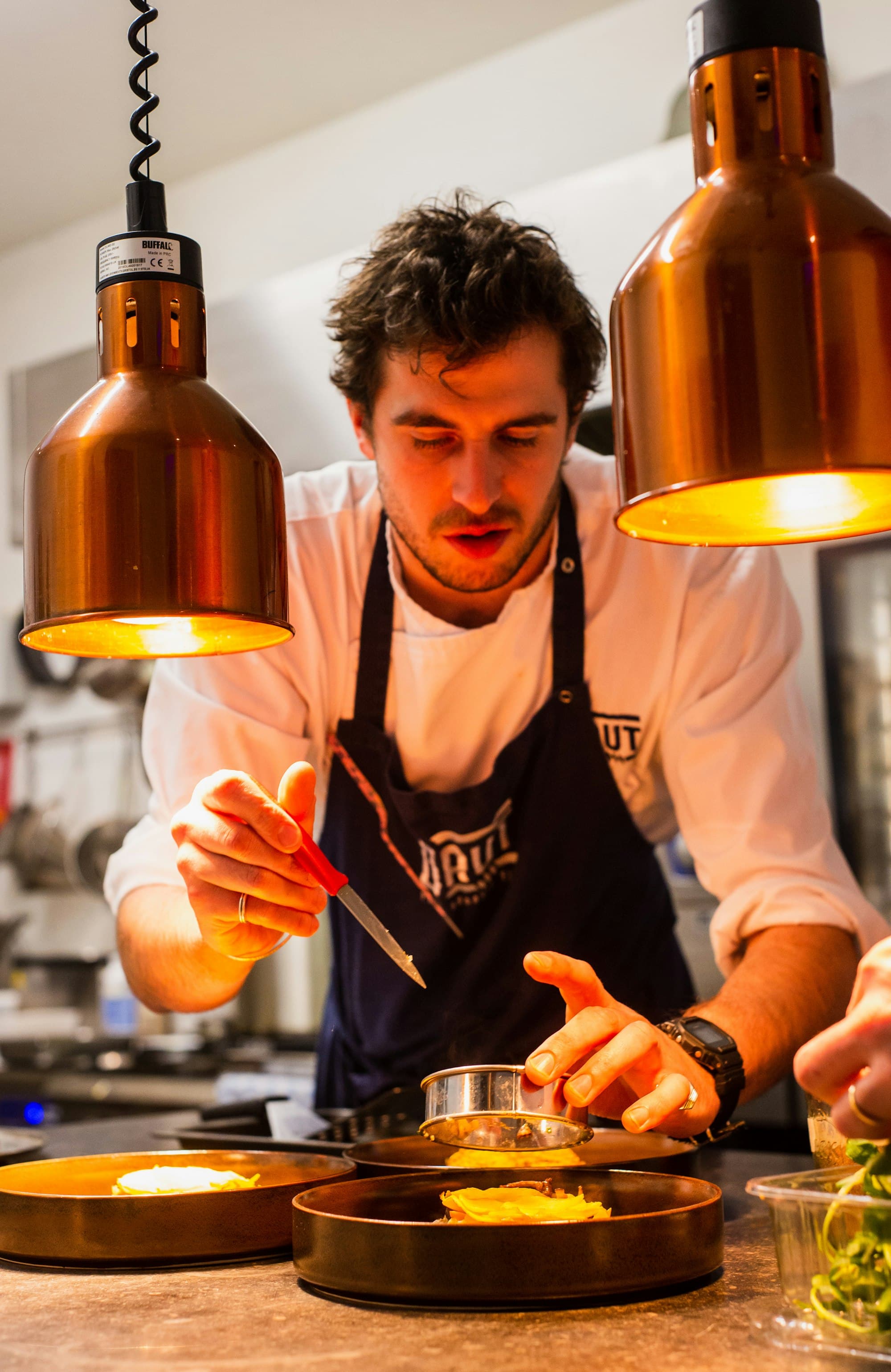 A Veens chef plating a dish